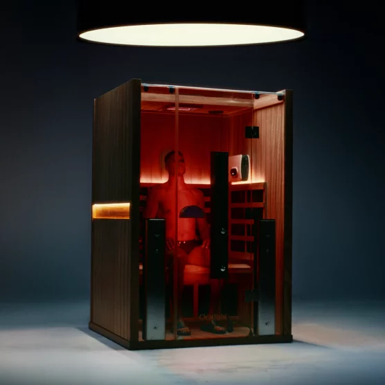 Red light filling the Clearlight Sauna with a person sitting inside