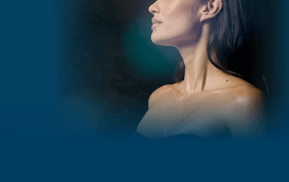 Close up view of a woman's face while spray tanning