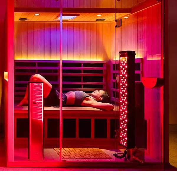 A person laying down in a red light therapy session.