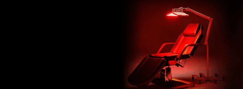 View of a chair with a red glow from red light therapy