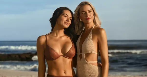 Two women on a sunny beach showcasing natural tan results