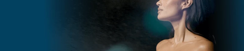 Close up view of a woman's face while spray tanning