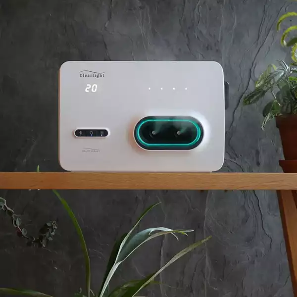 Small white rectangular device on a wooden shelf