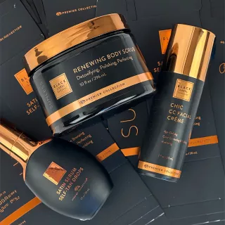 Palm Beach Tan Black Label Premier Collection products, including a renewing body scrub, chic CC facial crème, and satin serum self‑tan drops arranged on a branded background.