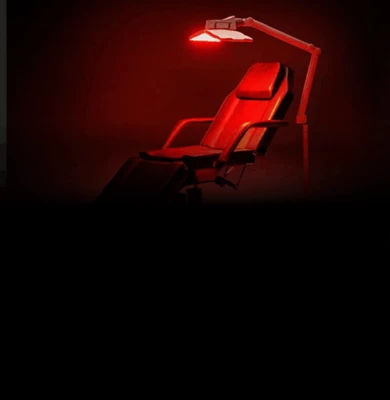 View of a chair with a red glow from red light therapy