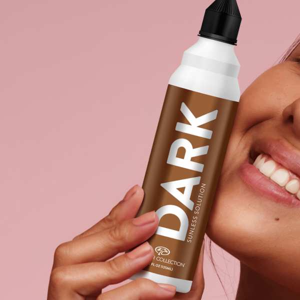Closeup of a woman’s face holding a spray can labeled ‘Dark’