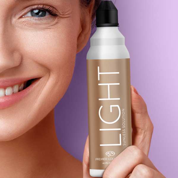 Closeup of a woman’s face holding a spray can labeled ‘Light’