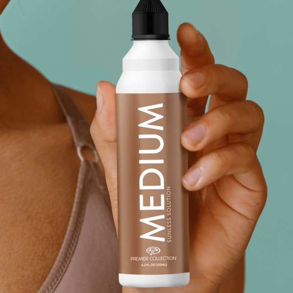 Closeup of a woman’s face holding a spray can labeled ‘Medium’